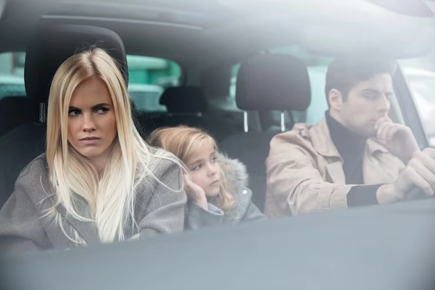 unhappy family in car